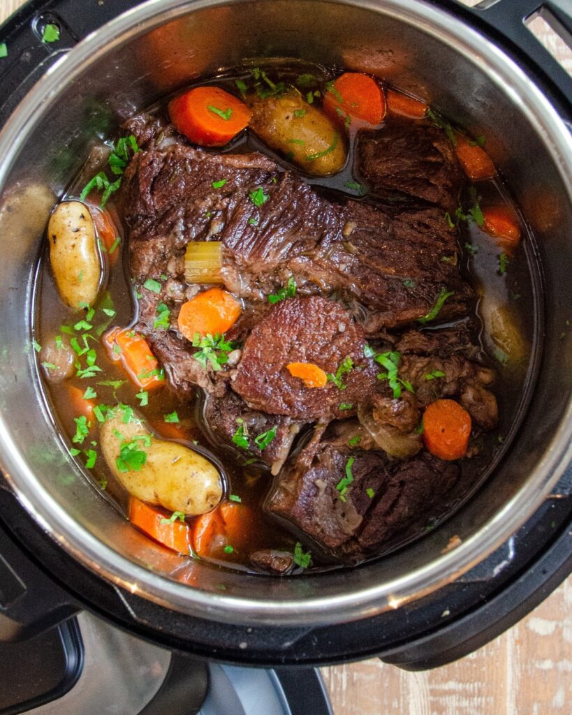Pot roast with vegetables and herbs in a pressure cooker