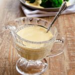 A gravy boat of cheese sauce.