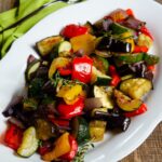 Roasted Vegetables on a white platter with a green napkin.