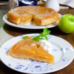 A piece of tart tatin on a blue and white plate.