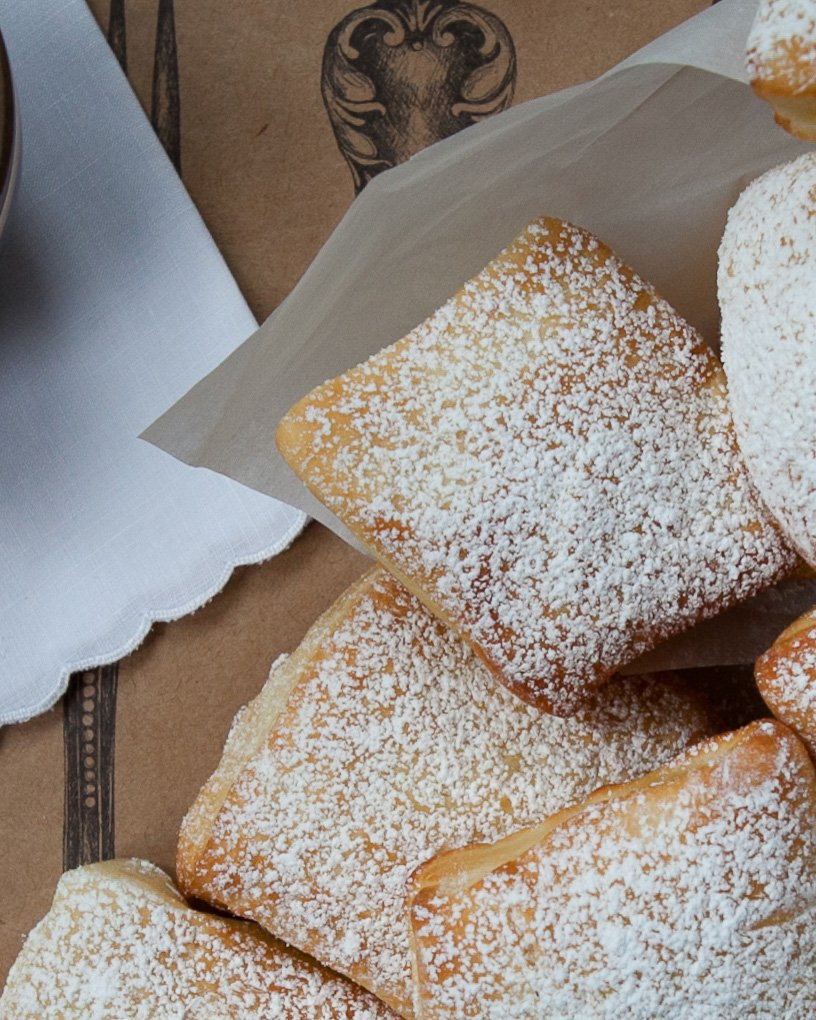 Looking straight down on some powdered sugared air-fried beignets.