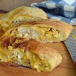 Chicken Cheesesteak stromboli on a wooden cutting board.