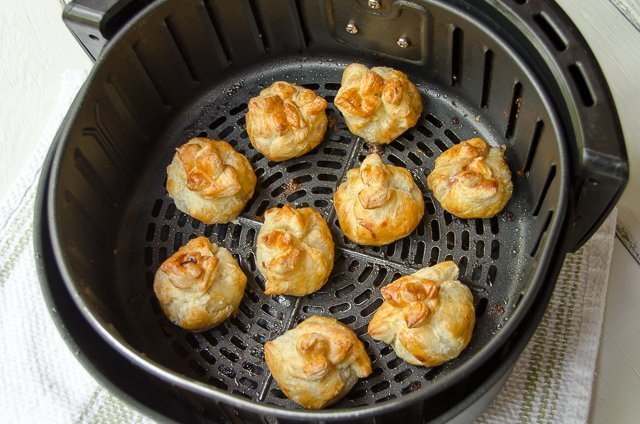 Mini Brie bites in an air fryer basket.