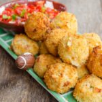 Spicy Chicken Bites on a foodball platter with salsa.