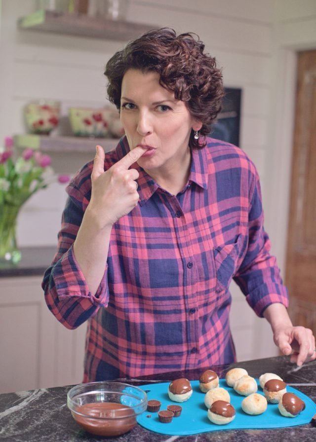 Meredith Laurence, Blue Jean Chef, sneaking a taste of chocolate while dipping doughnut holes.