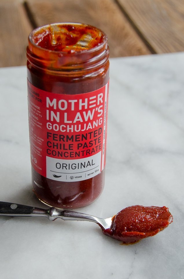 Jar of Mother-in-law's Gochujang with a spoon in front - an ingredient in Korean BBQ Chicken Lettuce Wraps