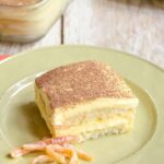 Grand Marnier TIramisu piece on a green plate with candied orange peel.