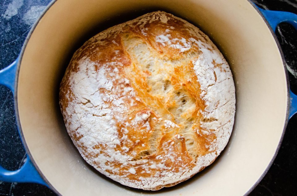 No Knead Bread after it has finished baking in the cast iron Dutch oven.