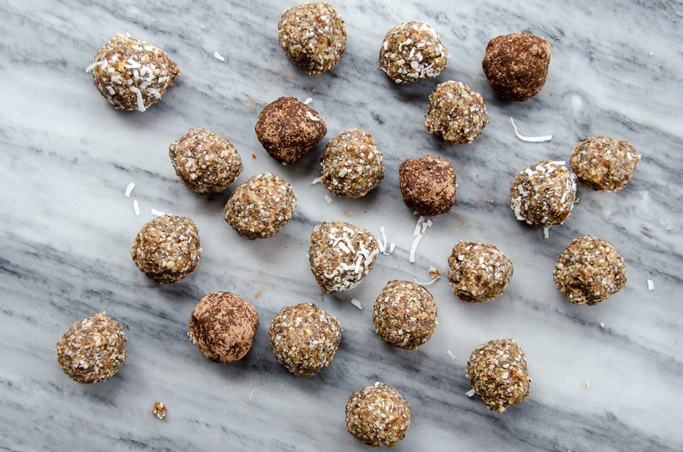 Paleo Power Bites scattered on a grey marble surface.