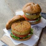 Two quinoa burgers on a platter.