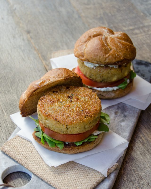Two quinoa burgers on a platter.
