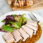 Soy Glazed Pork Chops on a white plate with salad.