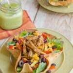 Turkey Tex Mex Salad in a tortilla bowl on a green plate.