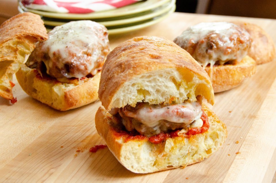 Air-fried pizza burgers on a wooden cutting board.