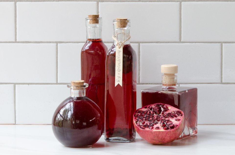 Four bottles of Pomegranate Fig White Balsamic Vinegar.