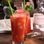 Sparkling watermelon coolers in tall glasses with green straws.