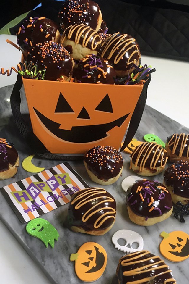 Halloween Chocolate Peanut Butter Doughnut Holes in a jack-o-lantern bucket.