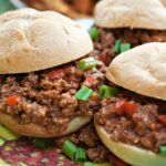 Close up of sloppy joes on a colorful plate.