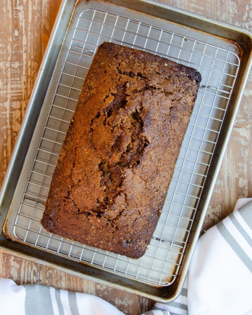 Carrot Cake Loaf on a cooling rack over a baking sheet.