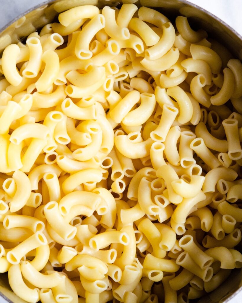 Macaroni, cooked and drained, in a stockpot.