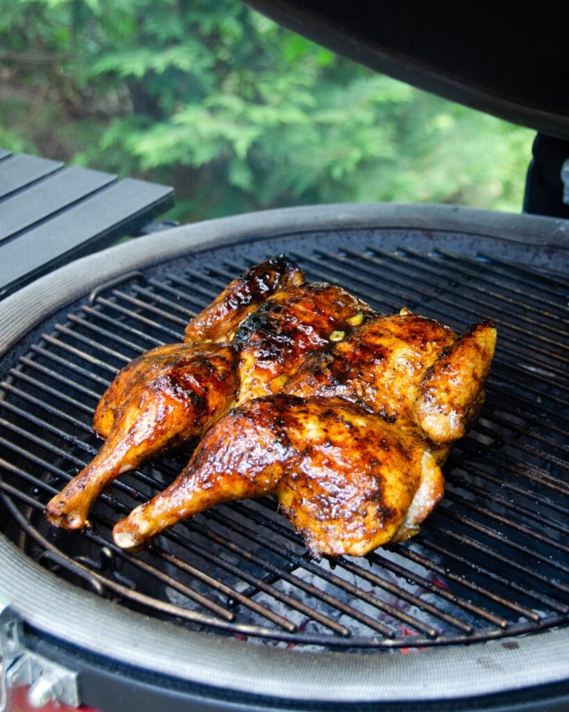 Orange spiced grilled spatchcocked chicken finished on the grill.