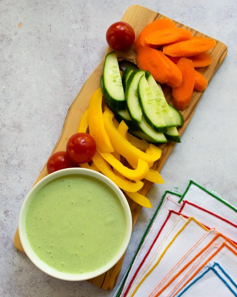 Green Goddess Dressing in a bowl with crudités.