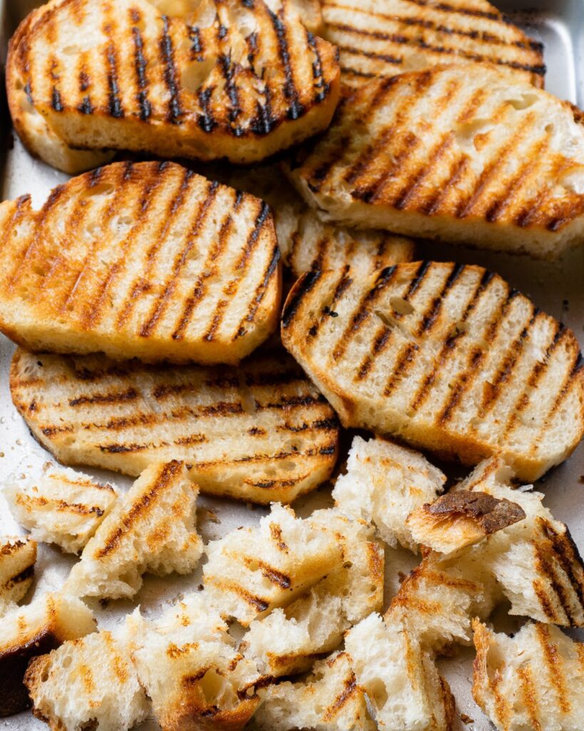 Grilled bread with some pieces torn.