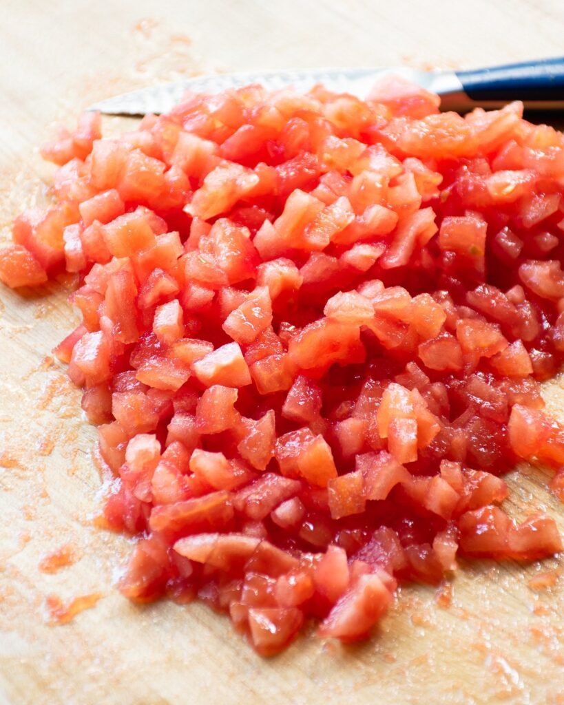 Chopped tomatoes on a cutting board.