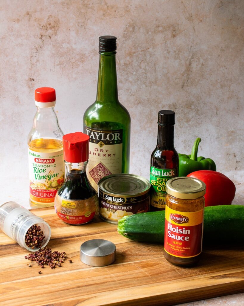 Ingredients for Kung Pao Chicken and Vegetables on a wooden cutting board.