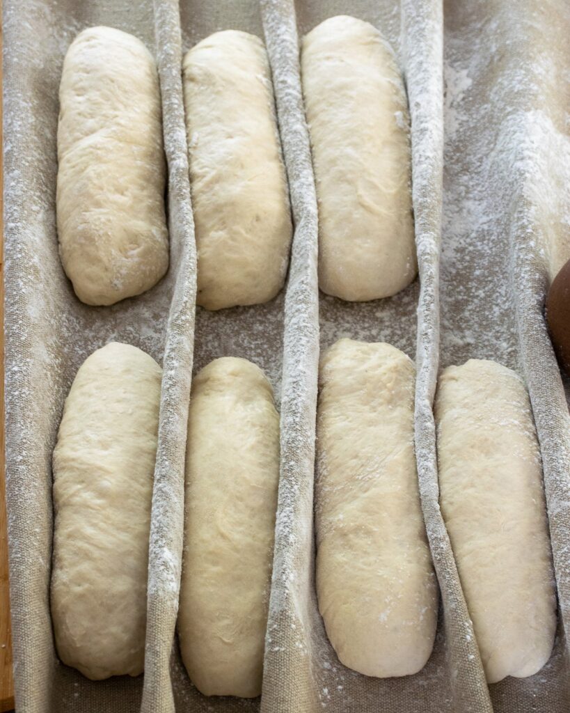 Baguette dough resting and rising on a linen couche.