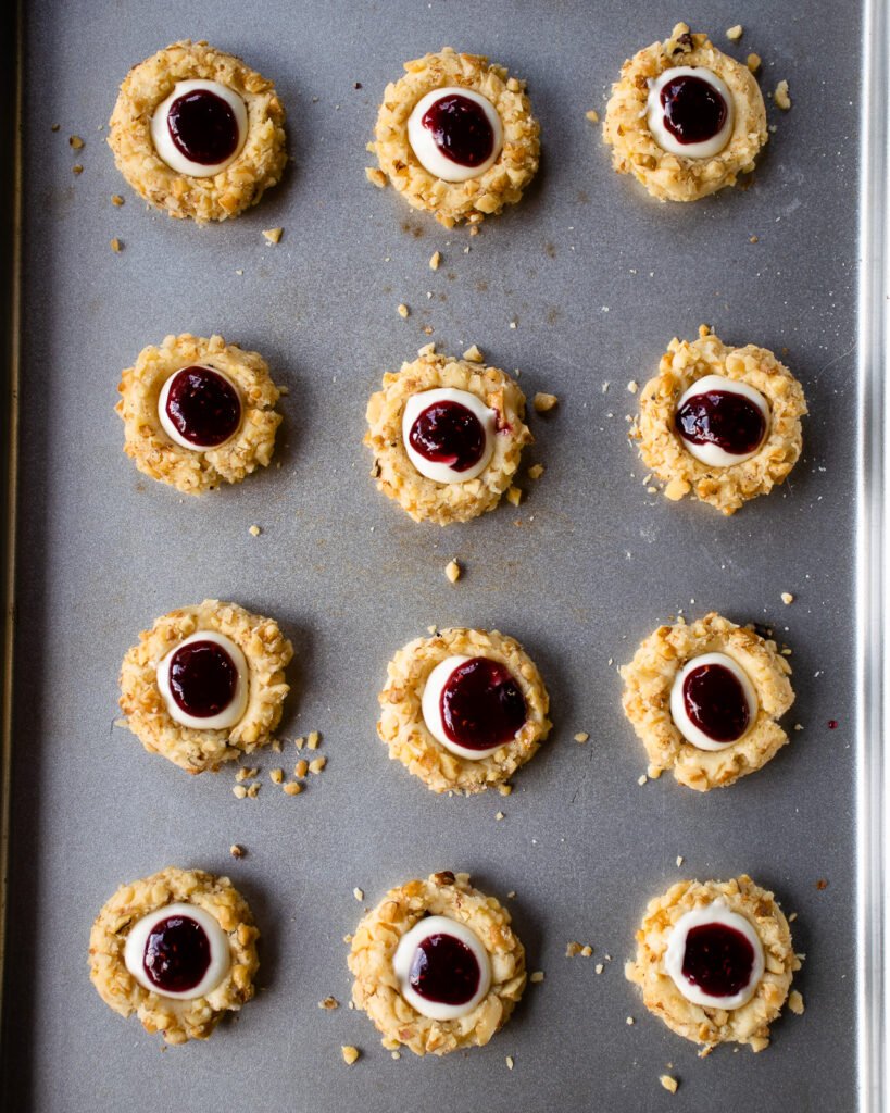 Thumbprint cookies on a baking sheet.