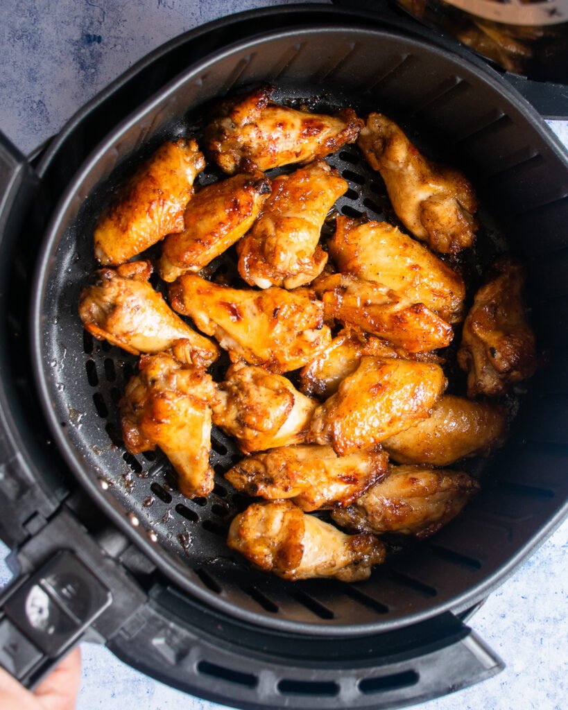 Orange Sesame Chicken Wings in an air fryer basket.