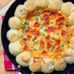 Skillet Pizza Dip in a non-stick skillet on a wooden table.