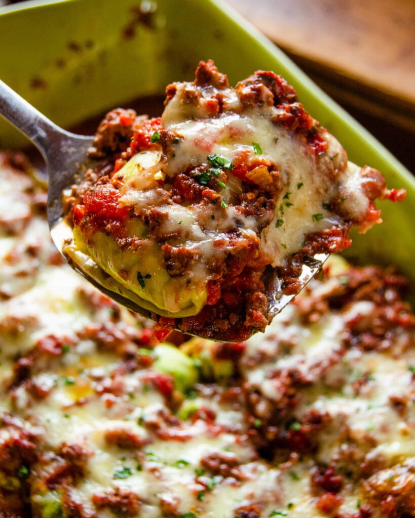 a spatula lifting up a portion of ricotta stuffed cabbage shells