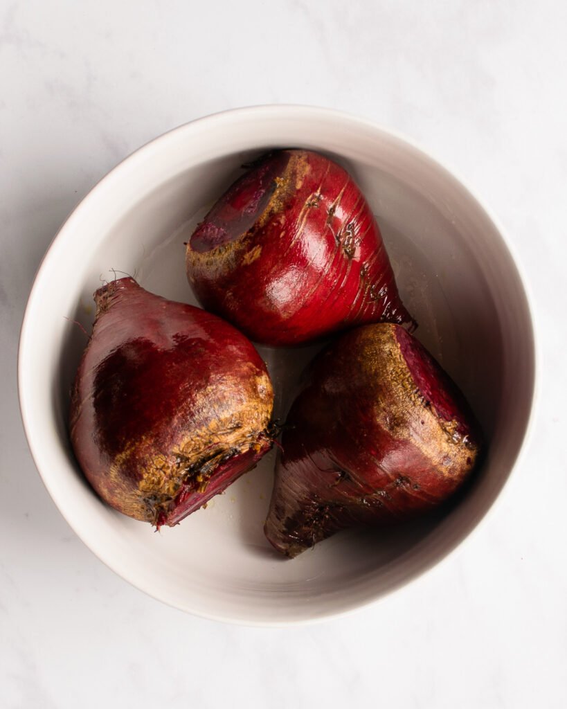 Raw beets in a ceramic dish.