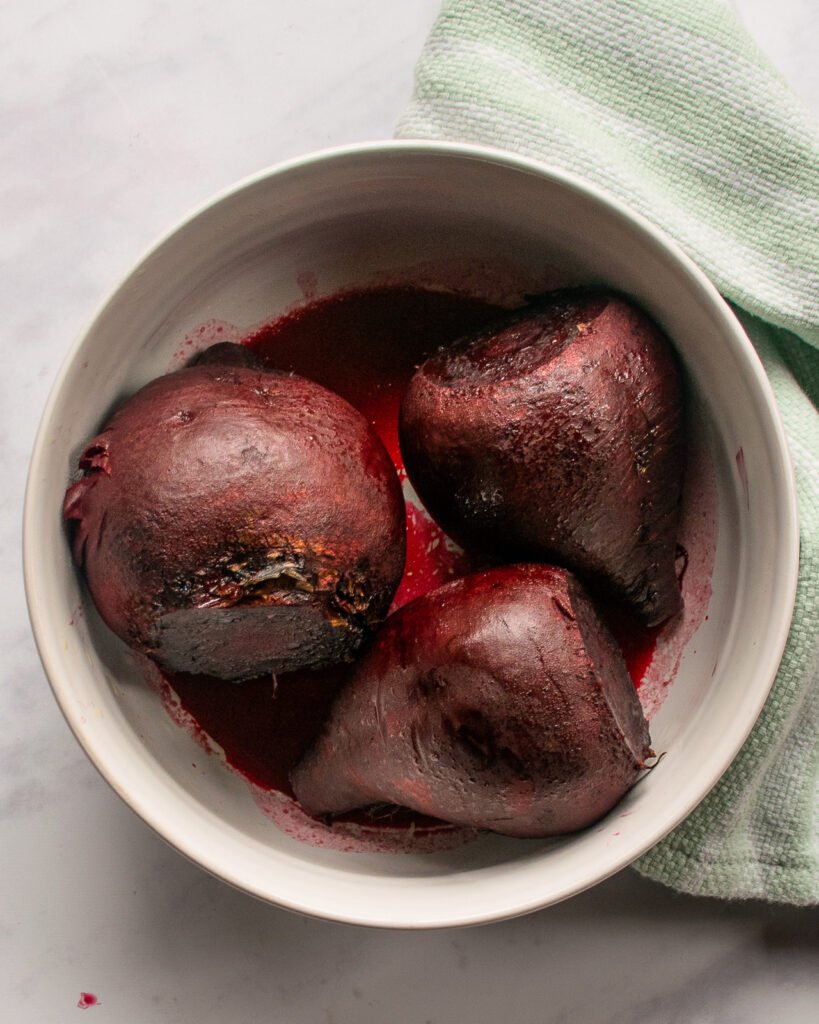 Cooked beets in a ceramic dish.