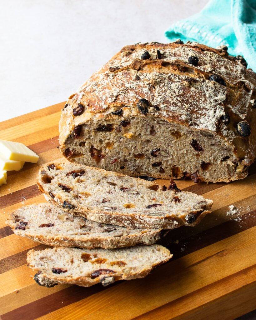 Bread sliced on a wooden cutting board.