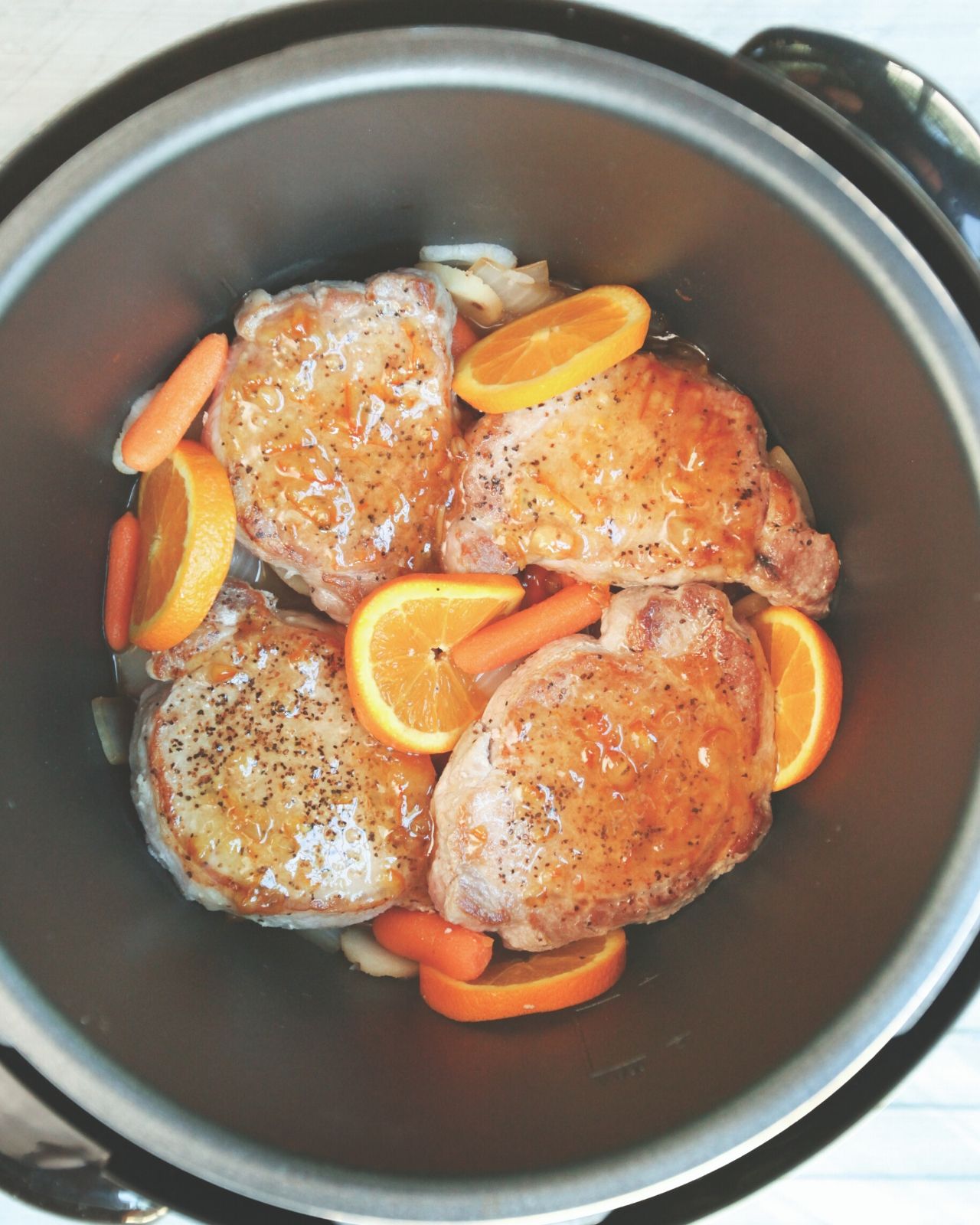 Seared pork chops in pressure cooker with vegetables