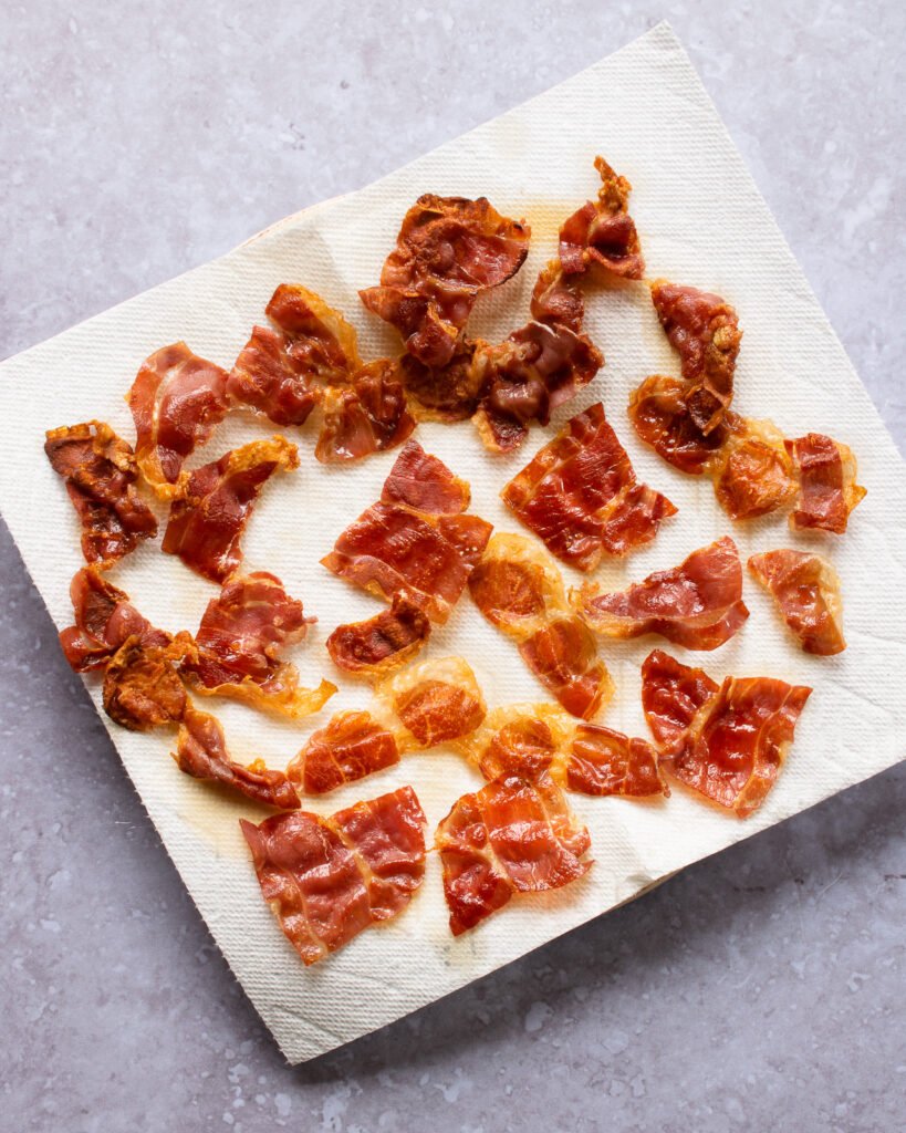 Crispy prosciutto on a paper towel lined plate.