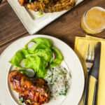 Huli Huli Chicken on white plate with greens and rice.