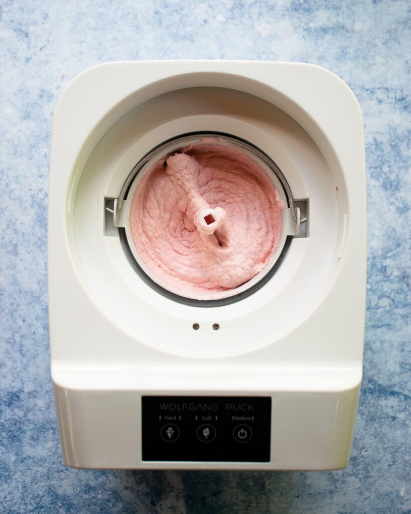 Strawberry ice Cream in an ice cream maker.