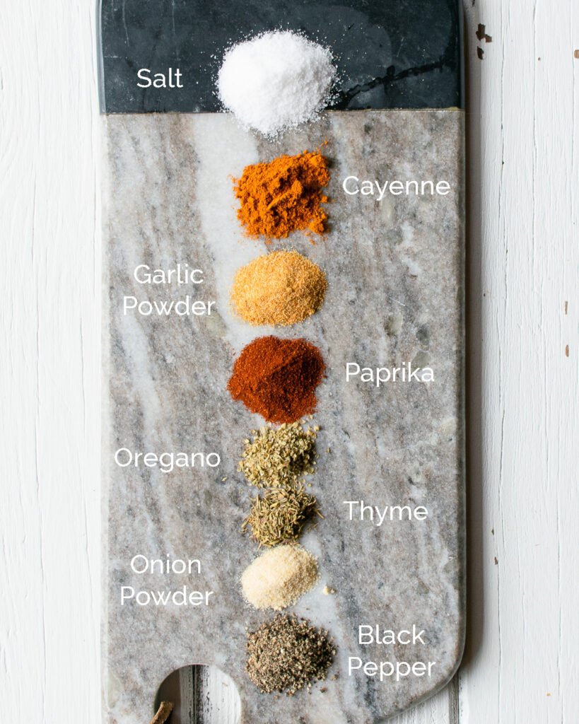 Spices on a marble board - the ingredients for Cajun spice mix.
