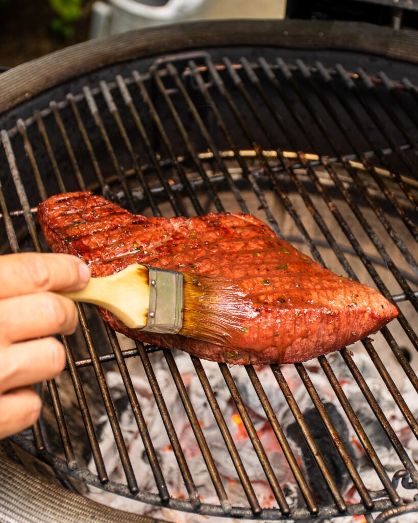 London Broil grilling while being basted.