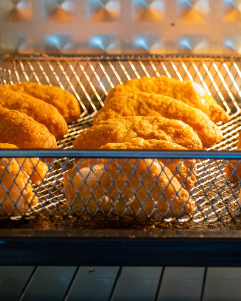 Apple fries cooking in an air fryer.