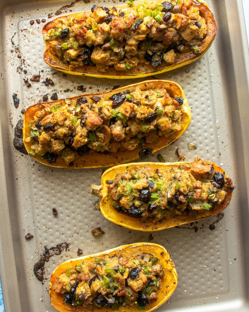 Baked Stuffed delicata squash on a baking sheet.