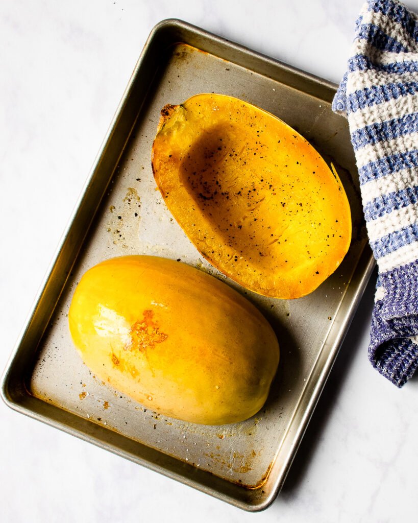 Cooked Spaghetti Squash on a baking sheet.