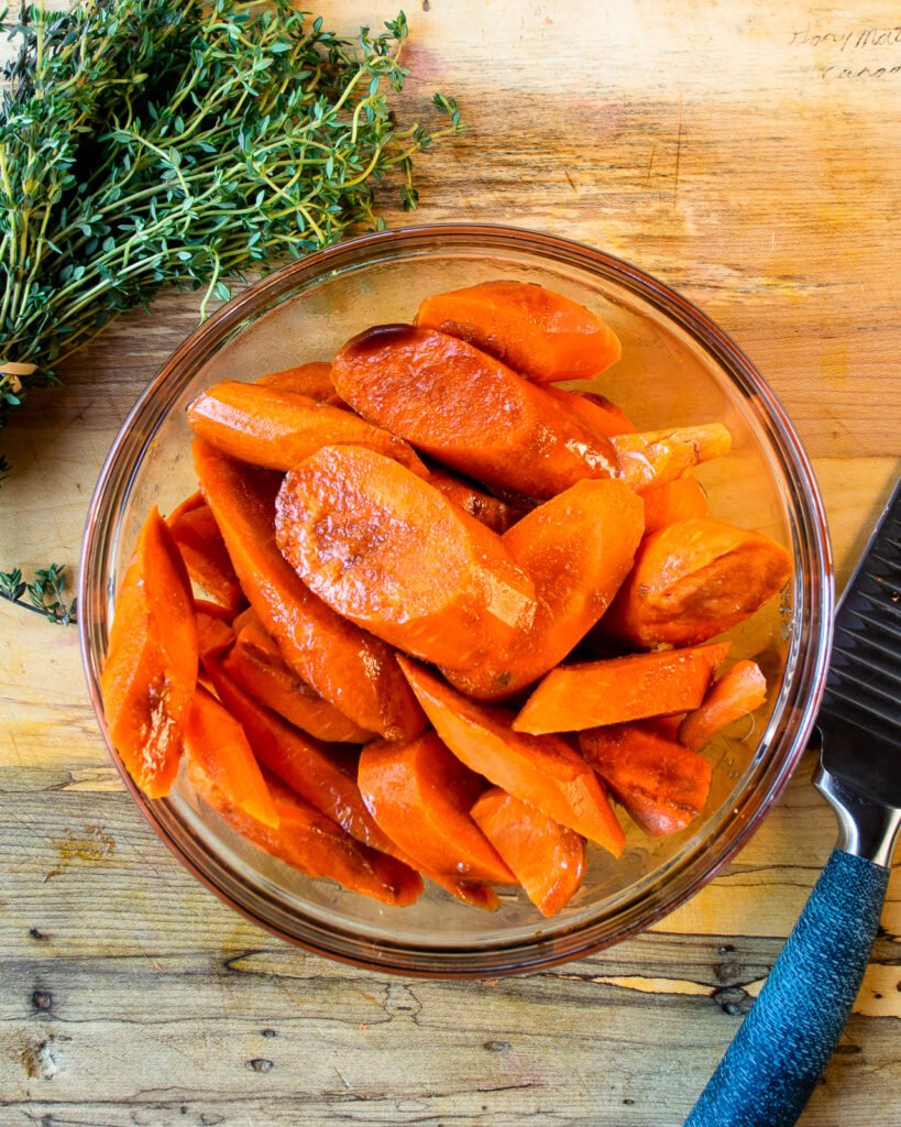 Carrots in a bowl tossed with balsamic glaze.