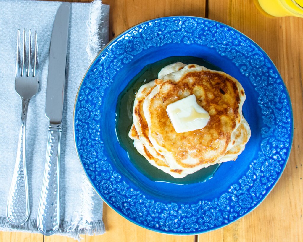 Looking straight down at a stack of sourdough buttermilk pancakes