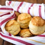Sourdough Buttermilk Biscuits in a red, white and yellow striped towel.