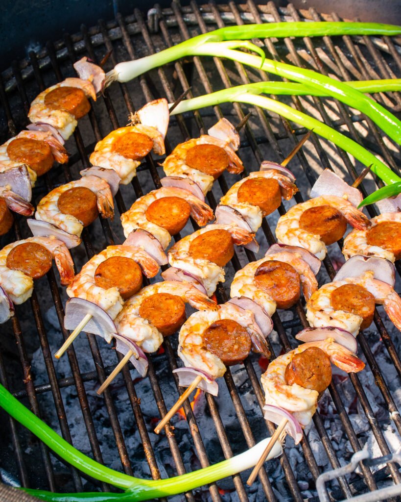 SHrimp and sausage skewers cooking on a grill